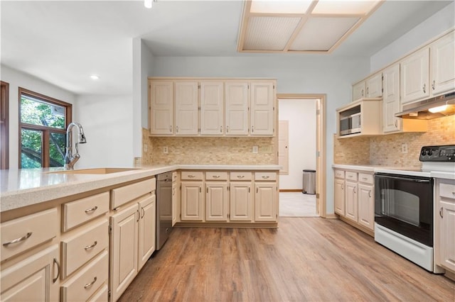 13109 W 65th St, Shawnee, KS 66216 - kitchen with appliances with stainless steel finishes, under cabinet range hood, light countertops, decorative backsplash, and recessed lighting