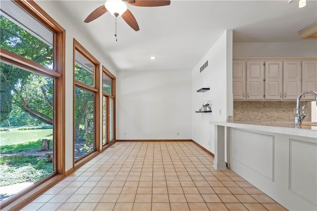 13109 W 65th St, Shawnee, KS 66216 - unfurnished dining area with ceiling fan and light tile patterned floors