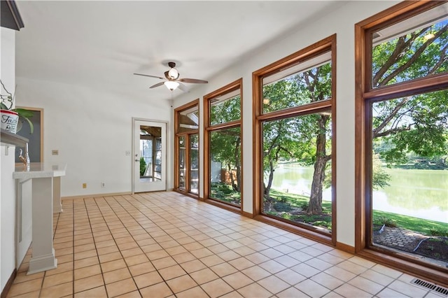 13109 W 65th St, Shawnee, KS 66216 - unfurnished sunroom featuring healthy amount of natural light, tile patterned floors, and a water view