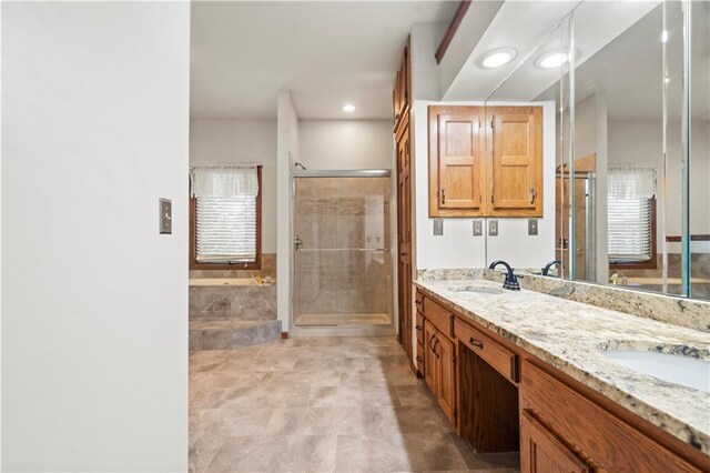 13109 W 65th St, Shawnee, KS 66216 - bathroom featuring double vanity, a bath, a shower stall, and recessed lighting