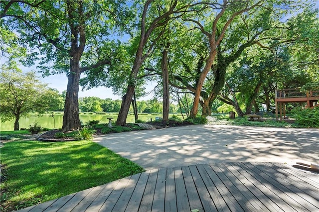 13109 W 65th St, Shawnee, KS 66216 - wooden terrace with view of wooded area and a yard