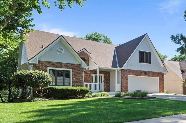 13109 W 65th St, Shawnee, KS 66216 - view of front of house featuring brick siding, a front yard, concrete driveway, and stucco siding