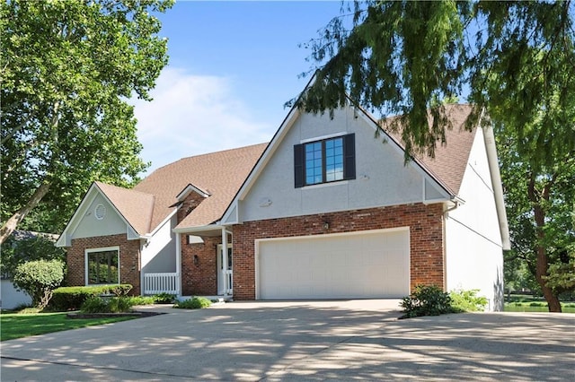 13109 W 65th St, Shawnee, KS 66216 - view of front facade with concrete driveway, brick siding, roof with shingles, and a garage
