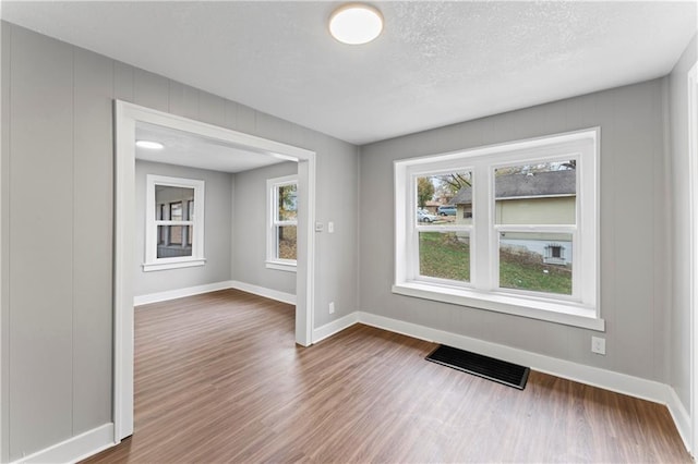 320 N Cedar Ave, Independence, MO 64053 - unfurnished room featuring dark wood-style floors and a textured ceiling