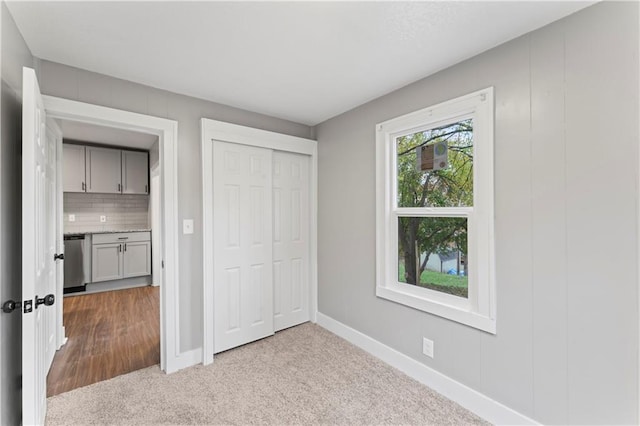 320 N Cedar Ave, Independence, MO 64053 - unfurnished bedroom featuring carpet and a closet