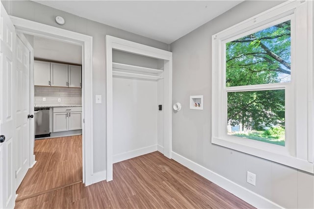 320 N Cedar Ave, Independence, MO 64053 - laundry room with healthy amount of natural light, light wood-type flooring, and hookup for a washing machine