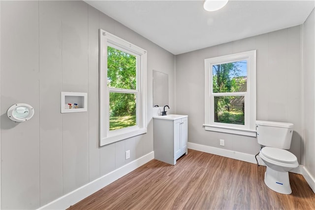320 N Cedar Ave, Independence, MO 64053 - bathroom with healthy amount of natural light, wood finished floors, and vanity