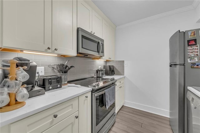 5015 Walnut St Unit A, Kansas City, MO 64112 - kitchen featuring appliances with stainless steel finishes, ornamental molding, light wood-style floors, tasteful backsplash, and light stone countertops