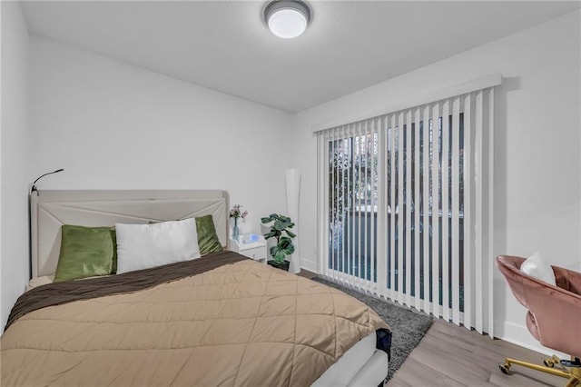 5015 Walnut St Unit A, Kansas City, MO 64112 - bedroom featuring wood finished floors and baseboards
