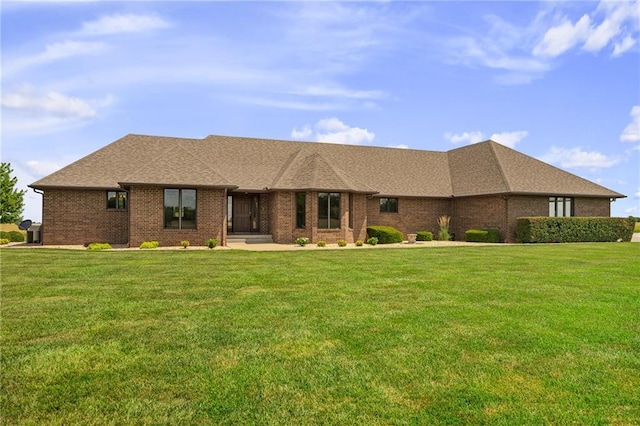 1001 E Park Rd, Garnett, KS 66032 - view of front facade with a front lawn, brick siding, and a shingled roof
