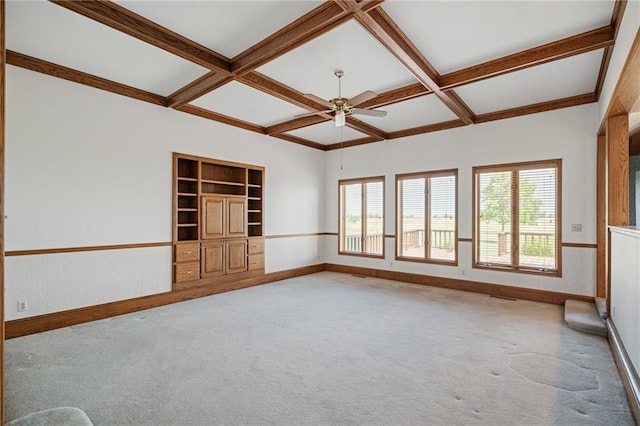 1001 E Park Rd, Garnett, KS 66032 - carpeted empty room featuring ceiling fan, coffered ceiling, beam ceiling, and built in features