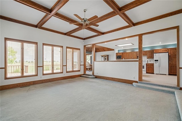 1001 E Park Rd, Garnett, KS 66032 - unfurnished living room featuring coffered ceiling, a ceiling fan, light carpet, and beamed ceiling