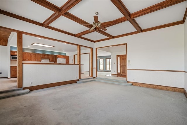 1001 E Park Rd, Garnett, KS 66032 - unfurnished living room featuring coffered ceiling, light carpet, a ceiling fan, and beamed ceiling
