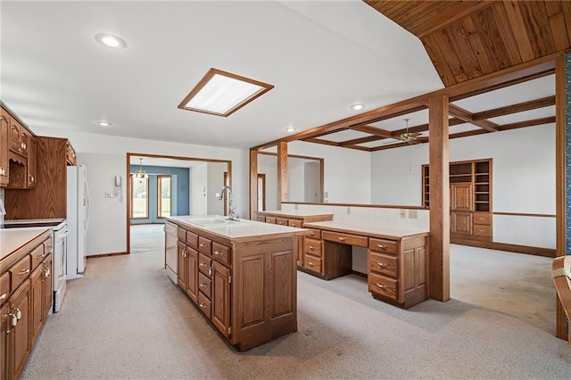1001 E Park Rd, Garnett, KS 66032 - kitchen featuring white appliances, a kitchen island with sink, a desk, recessed lighting, and light colored carpet