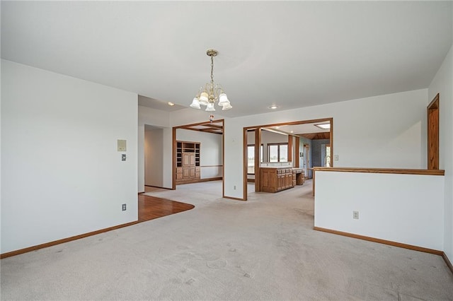 1001 E Park Rd, Garnett, KS 66032 - spare room with light colored carpet and a chandelier
