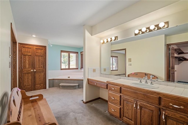 1001 E Park Rd, Garnett, KS 66032 - bathroom featuring a bath, vanity, and a closet