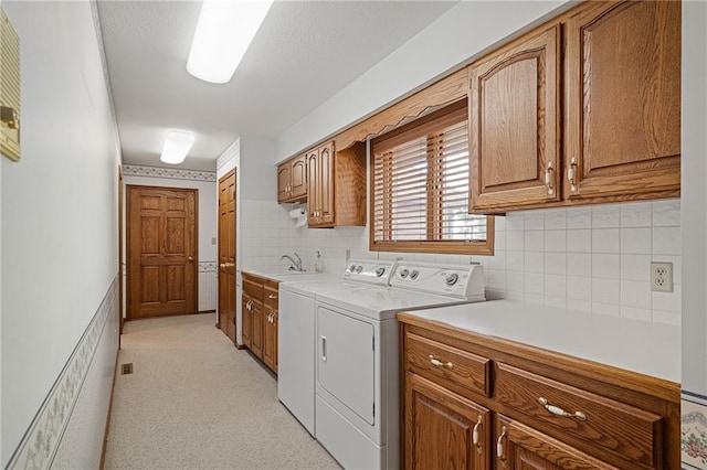 1001 E Park Rd, Garnett, KS 66032 - washroom with cabinet space, independent washer and dryer, and light colored carpet