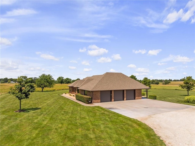 1001 E Park Rd, Garnett, KS 66032 - view of front of home featuring driveway, a front lawn, brick siding, and a shingled roof