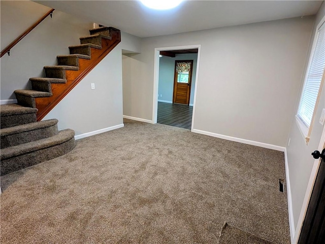710 E Vine St, Iola, KS 66749 - below grade area featuring stairs, carpet floors, and plenty of natural light
