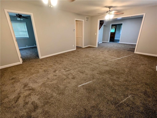 710 E Vine St, Iola, KS 66749 - empty room with ceiling fan, dark carpet, and healthy amount of natural light