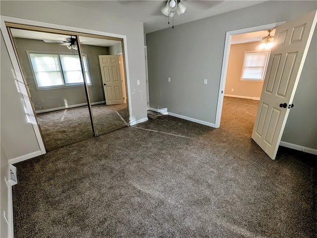 710 E Vine St, Iola, KS 66749 - unfurnished bedroom with dark carpet, a closet, and ceiling fan