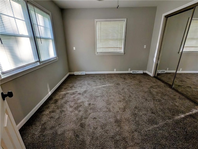 710 E Vine St, Iola, KS 66749 - unfurnished bedroom featuring carpet and a closet