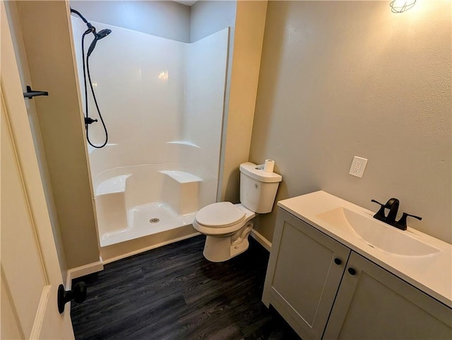 710 E Vine St, Iola, KS 66749 - bathroom with wood finished floors, a shower, and vanity