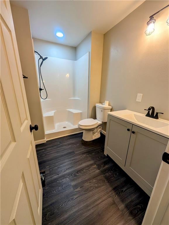 710 E Vine St, Iola, KS 66749 - full bathroom with wood finished floors, a shower, and vanity