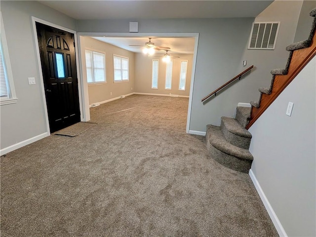 710 E Vine St, Iola, KS 66749 - foyer entrance featuring carpet floors, stairs, and ceiling fan