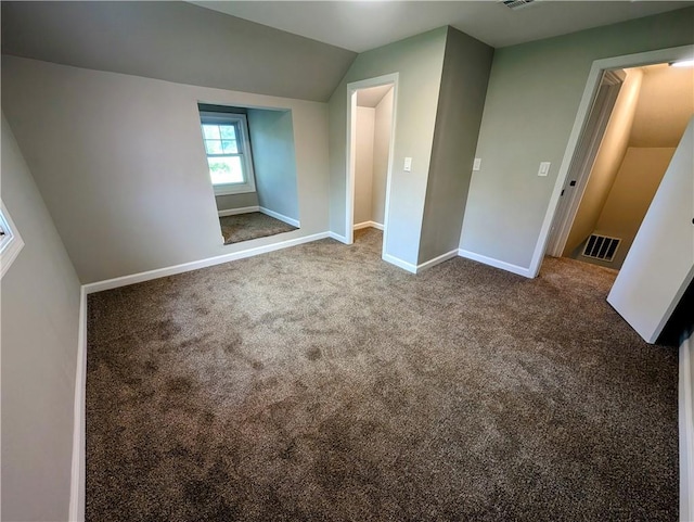710 E Vine St, Iola, KS 66749 - unfurnished bedroom featuring vaulted ceiling and carpet flooring