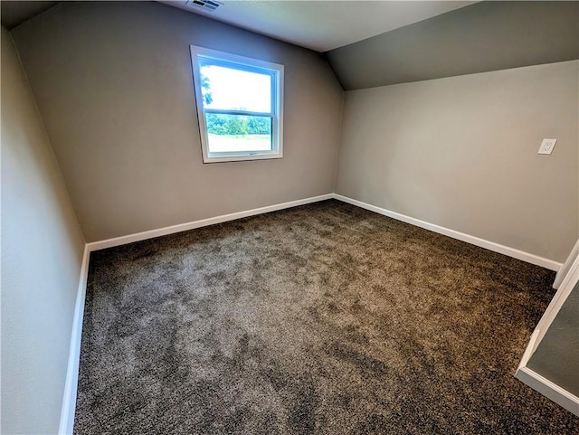 710 E Vine St, Iola, KS 66749 - bonus room with dark colored carpet and vaulted ceiling