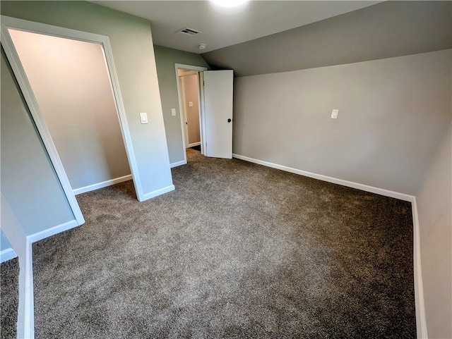 710 E Vine St, Iola, KS 66749 - unfurnished bedroom featuring lofted ceiling and carpet