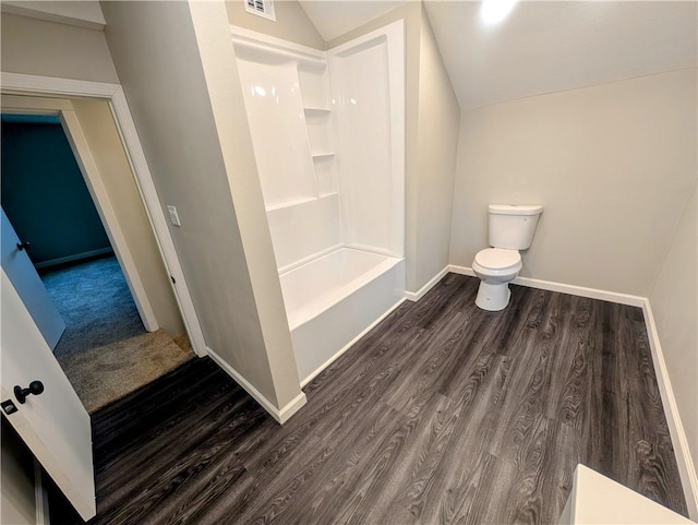 710 E Vine St, Iola, KS 66749 - bathroom with wood finished floors, lofted ceiling, and shower / bathtub combination