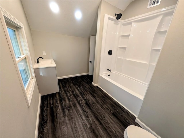 710 E Vine St, Iola, KS 66749 - full bath with vaulted ceiling, wood finished floors, vanity, and  shower combination