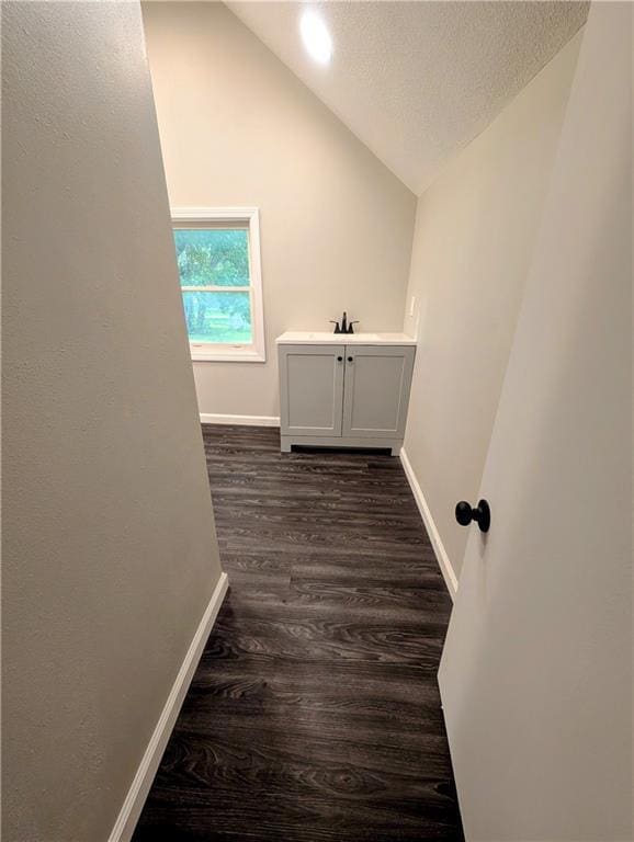 710 E Vine St, Iola, KS 66749 - washroom featuring dark wood-type flooring and a textured ceiling