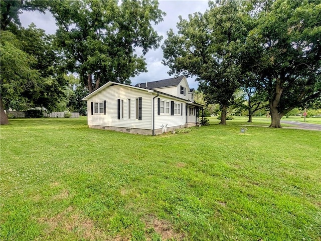 710 E Vine St, Iola, KS 66749 - view of home's exterior featuring a lawn and crawl space