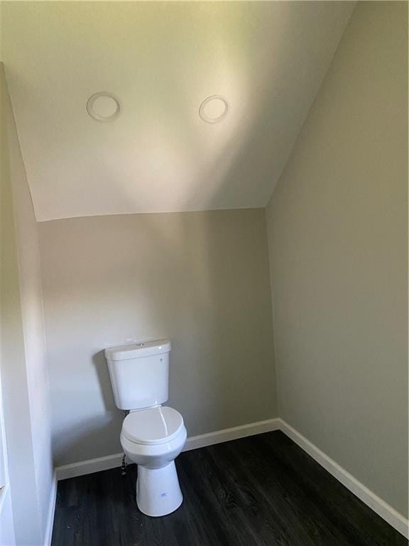 710 E Vine St, Iola, KS 66749 - bathroom featuring vaulted ceiling and wood finished floors