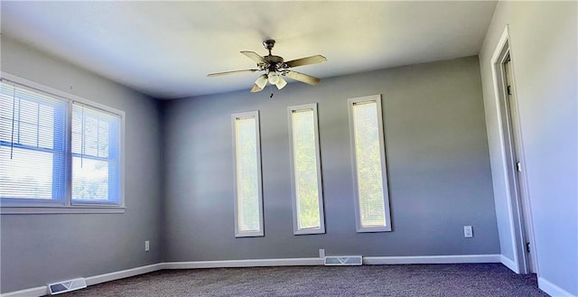 710 E Vine St, Iola, KS 66749 - unfurnished room featuring dark carpet and ceiling fan