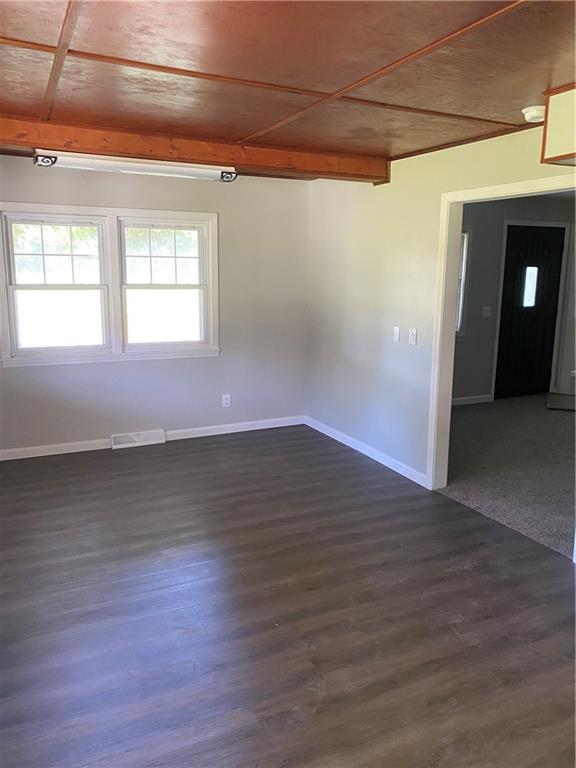 710 E Vine St, Iola, KS 66749 - empty room featuring dark wood-type flooring