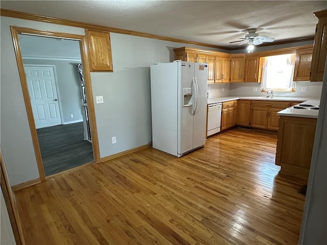 131 E Warren St, Gardner, KS 66030 - kitchen with white appliances, crown molding, light countertops, light wood-style flooring, and a ceiling fan