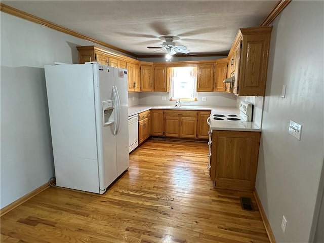131 E Warren St, Gardner, KS 66030 - kitchen featuring white appliances, a ceiling fan, light countertops, under cabinet range hood, and light wood finished floors