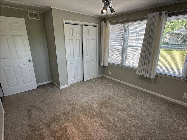 131 E Warren St, Gardner, KS 66030 - unfurnished bedroom with carpet floors, crown molding, a closet, and a ceiling fan