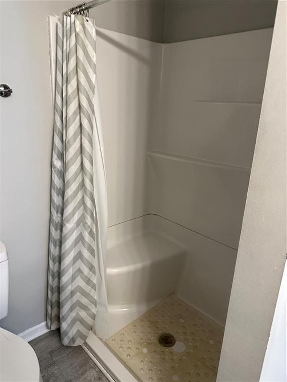 131 E Warren St, Gardner, KS 66030 - bathroom featuring toilet and curtained shower