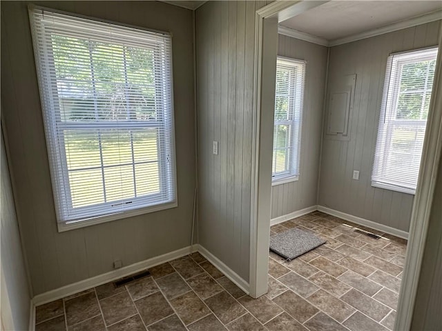 131 E Warren St, Gardner, KS 66030 - doorway with wood walls, ornamental molding, and dark stone finish flooring
