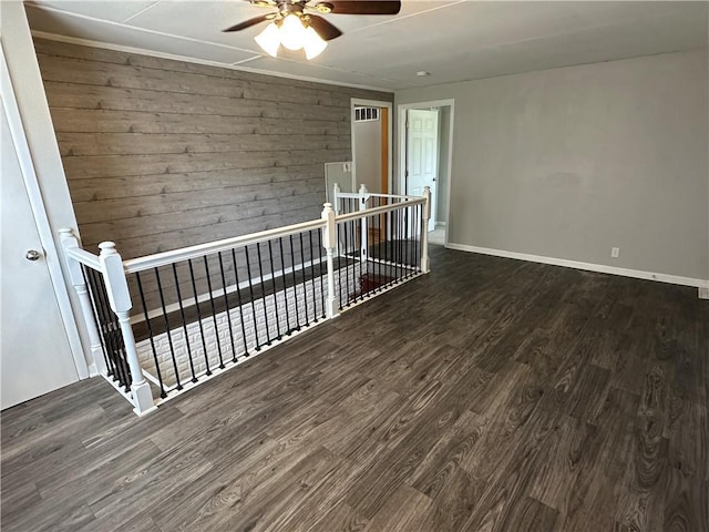 131 E Warren St, Gardner, KS 66030 - unfurnished room featuring wood finished floors, ceiling fan, and wood walls