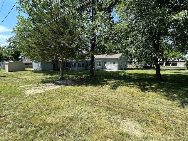 131 E Warren St, Gardner, KS 66030 - view of grassy yard featuring a storage shed