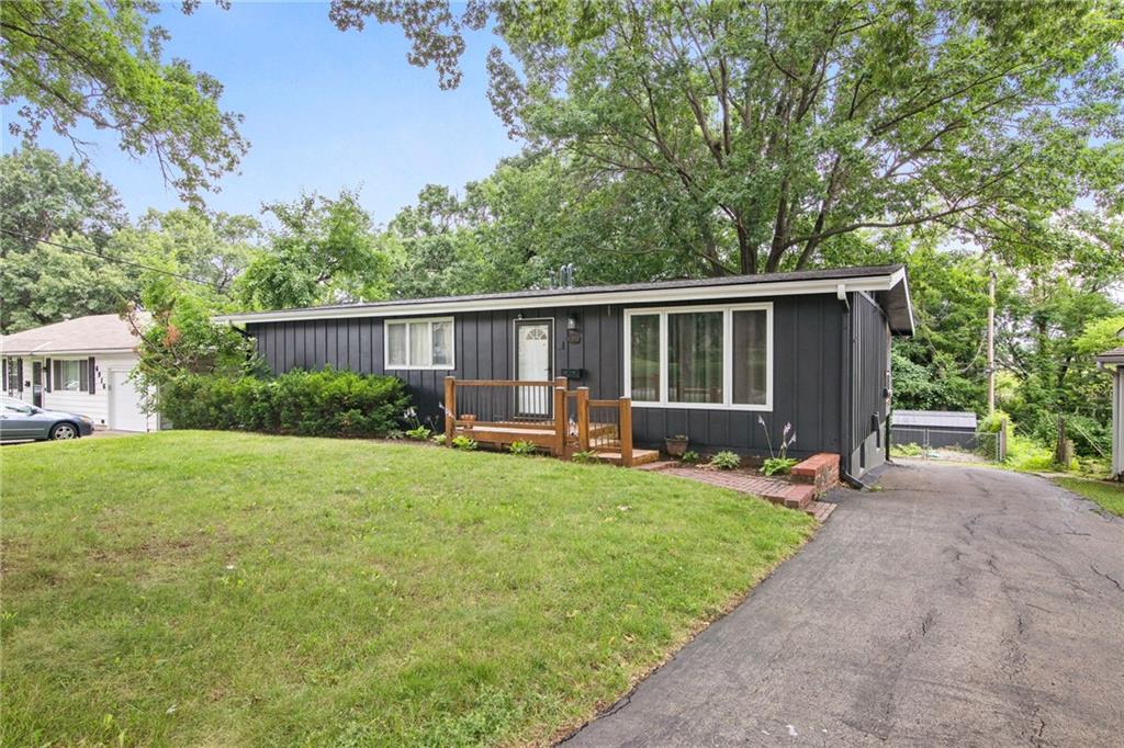 6910 Kessler St, Merriam, KS 66204 - single story home with board and batten siding and a front yard
