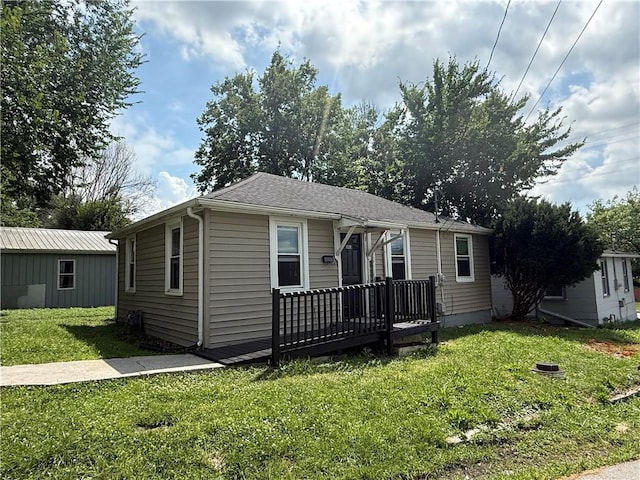 303 Bell St, Richmond, MO 64085 - view of front of house featuring a front yard and a deck