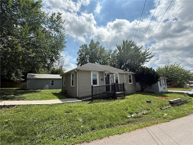 303 Bell St, Richmond, MO 64085 - view of front of house featuring a front lawn and a wooden deck