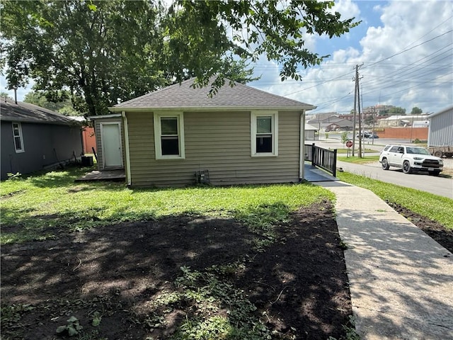 303 Bell St, Richmond, MO 64085 - view of property exterior with a yard and roof with shingles